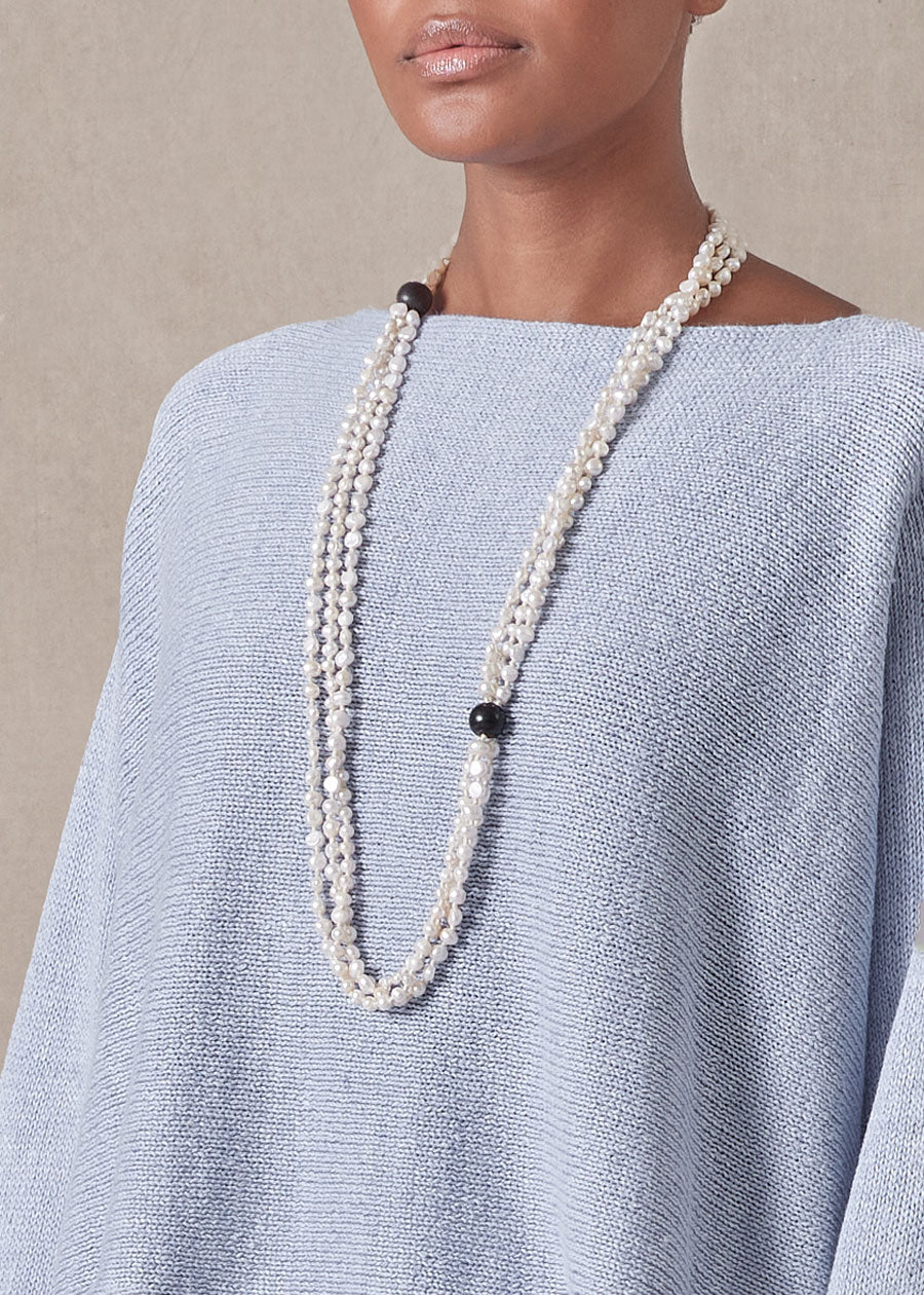 triple strand pearl necklace with wooden bead detail