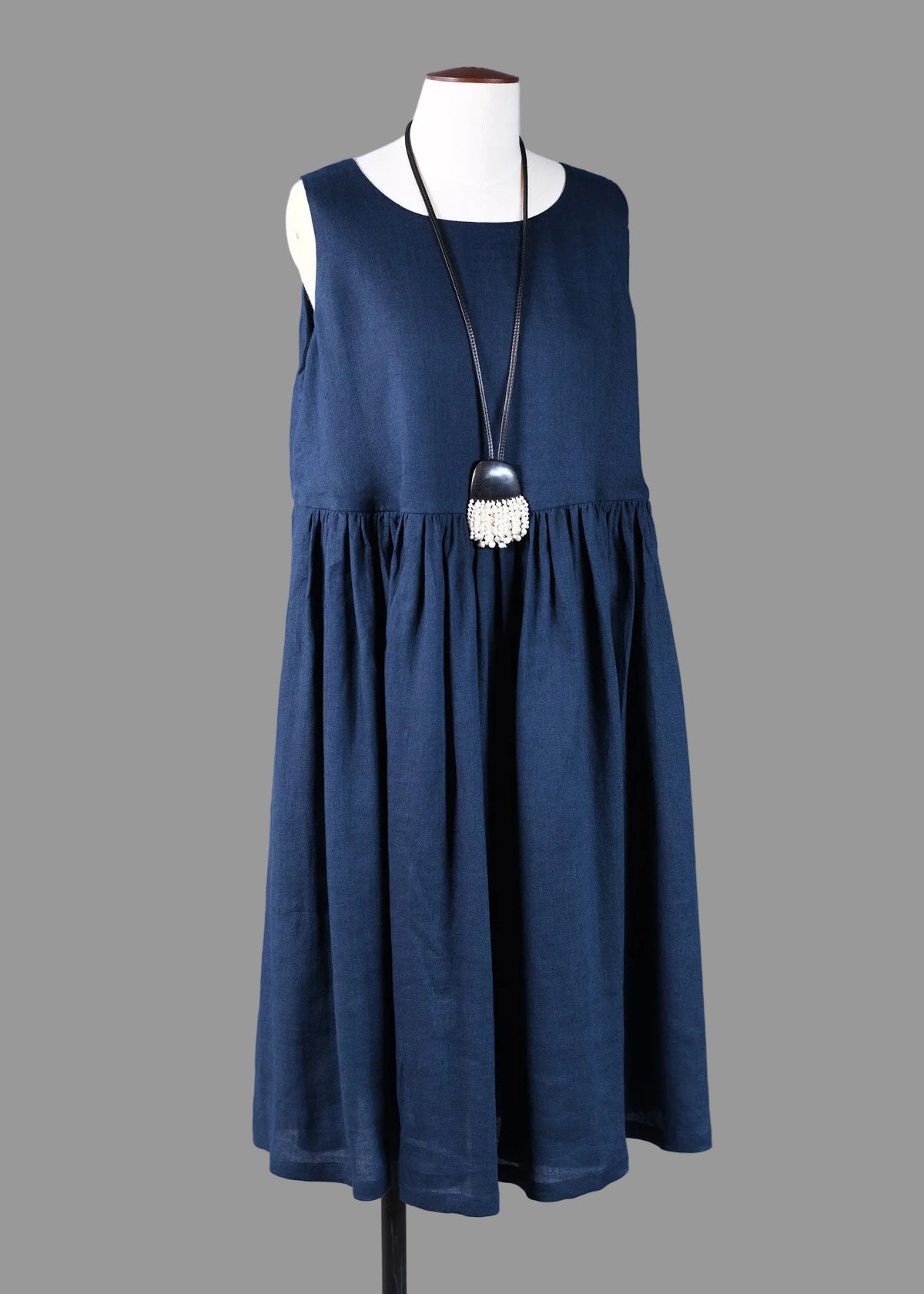 handkerchief linen sleeveless round neck dress with full pleated skirt