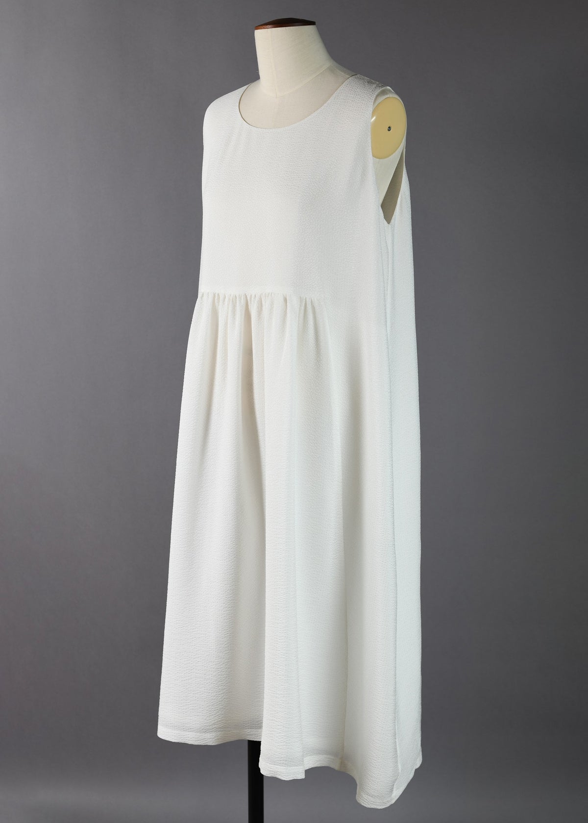 sleeveless round neck dress with 'pleated panels'