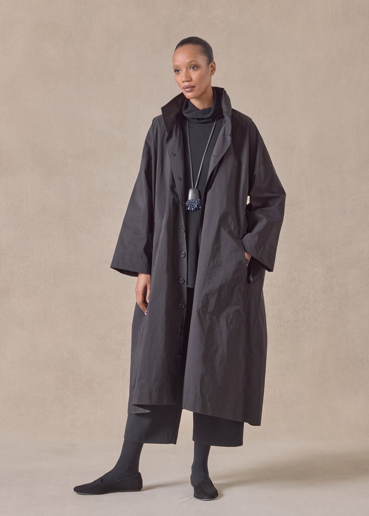 cotton mix smaller front larger back high neck raincoat with button away hood - full length