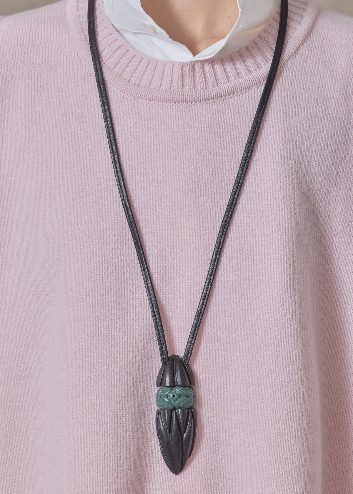 carved kamagong oval pendant with hand carved jade insert