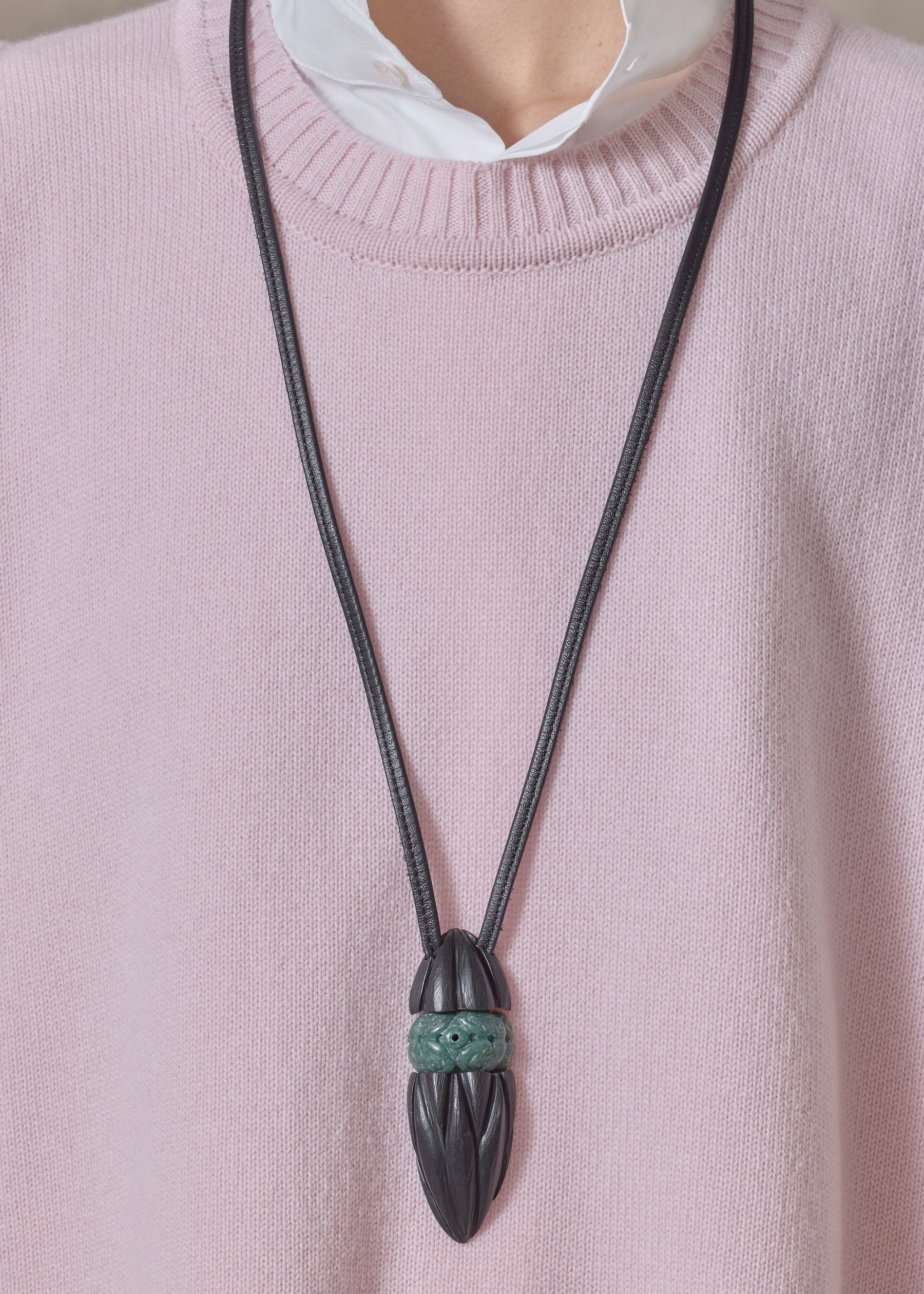 carved kamagong oval pendant with hand carved jade insert