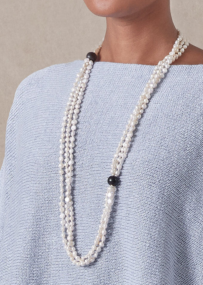 triple strand pearl necklace with wooden bead detail