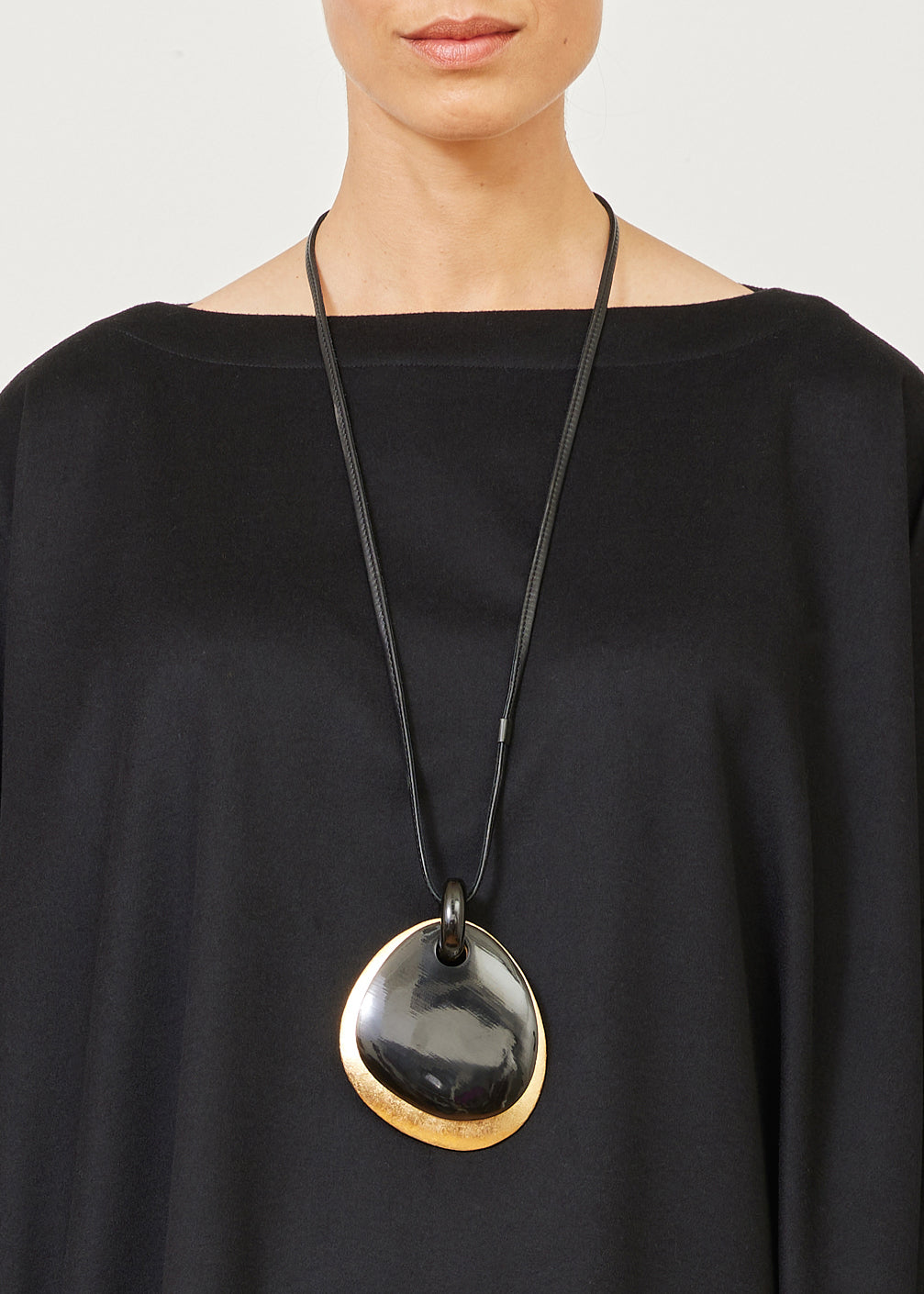 two part elliptical black and gold pendant