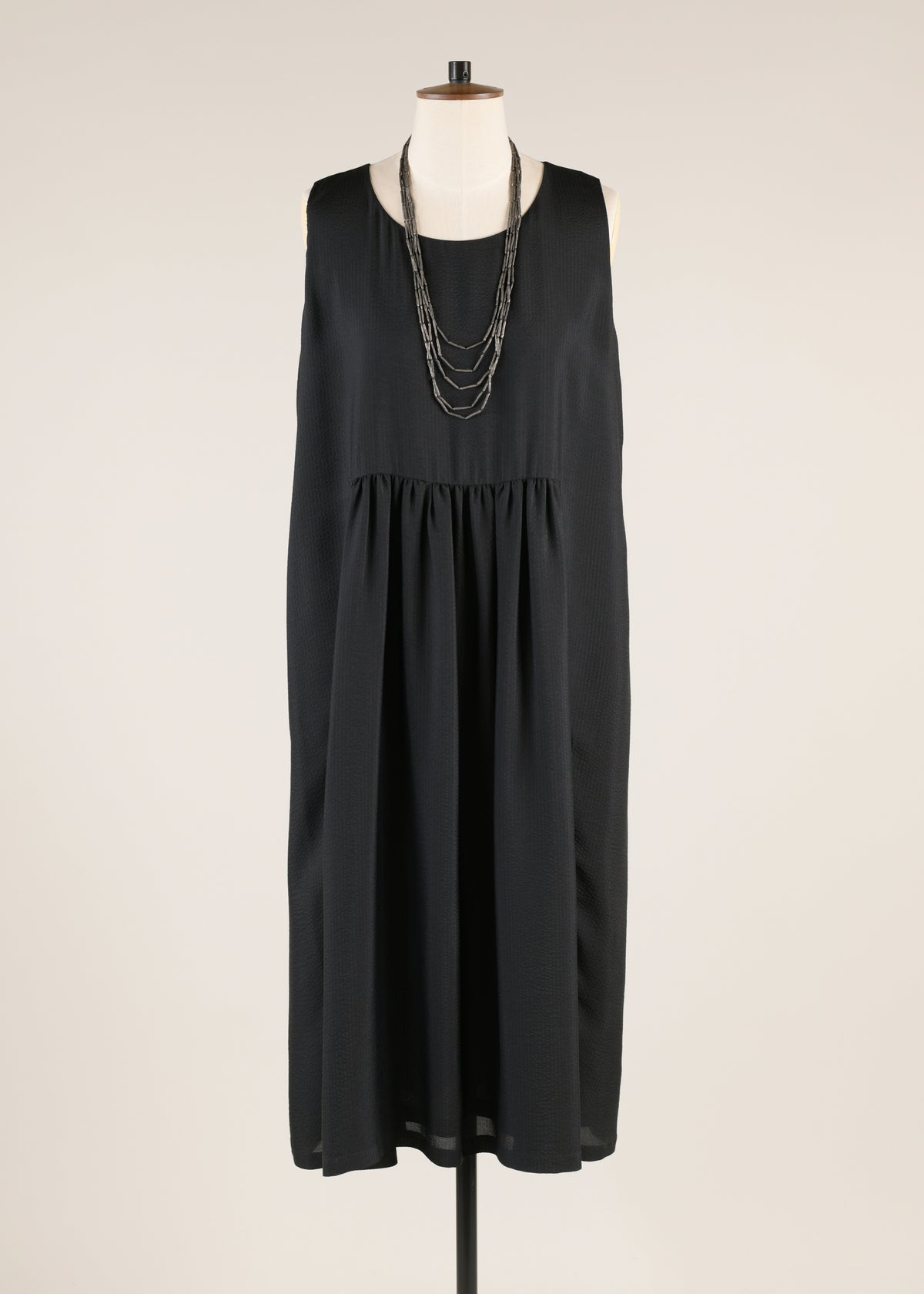 silk sleeveless round neck dress with 'pleated panels'
