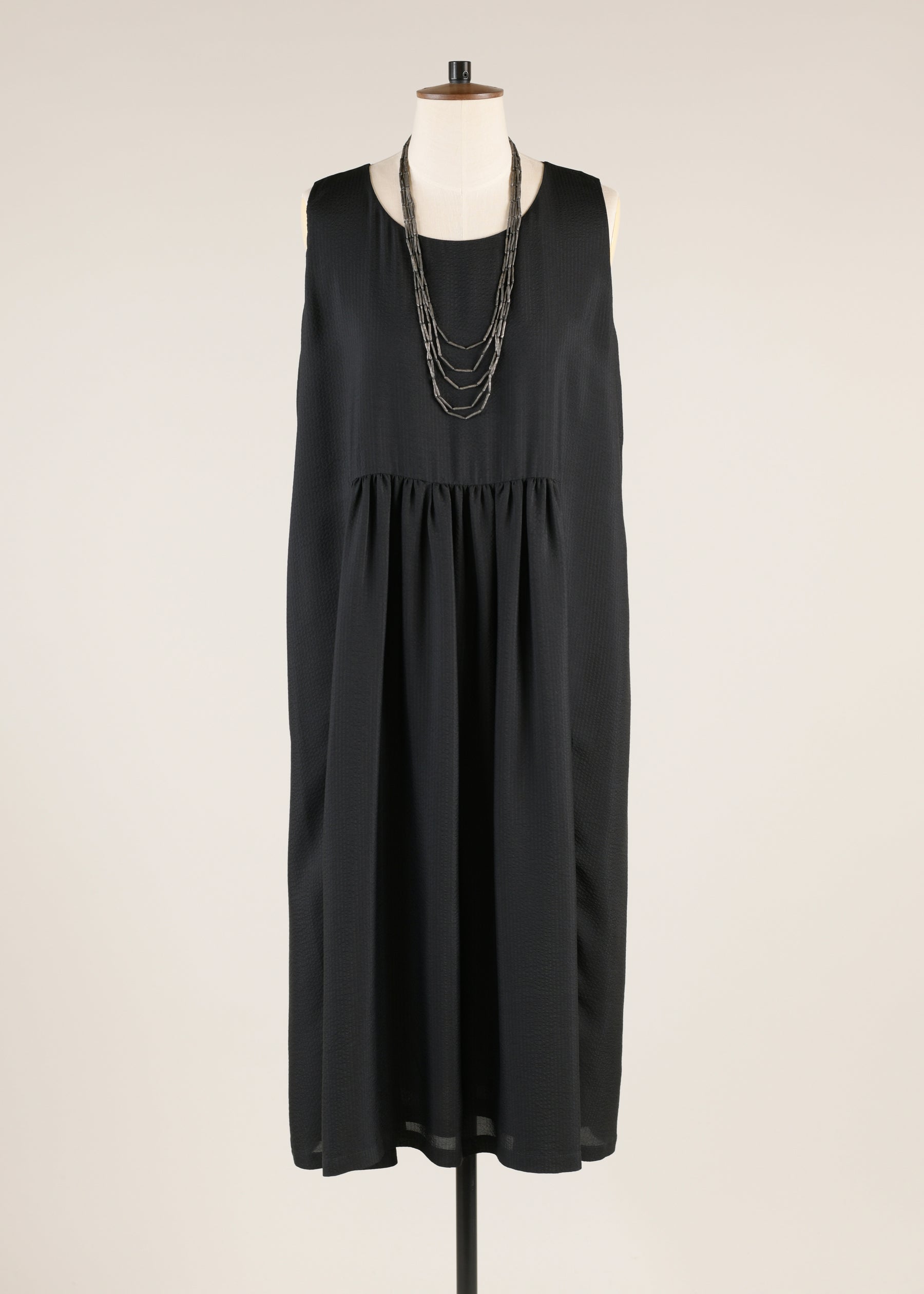 silk sleeveless round neck dress with 'pleated panels'