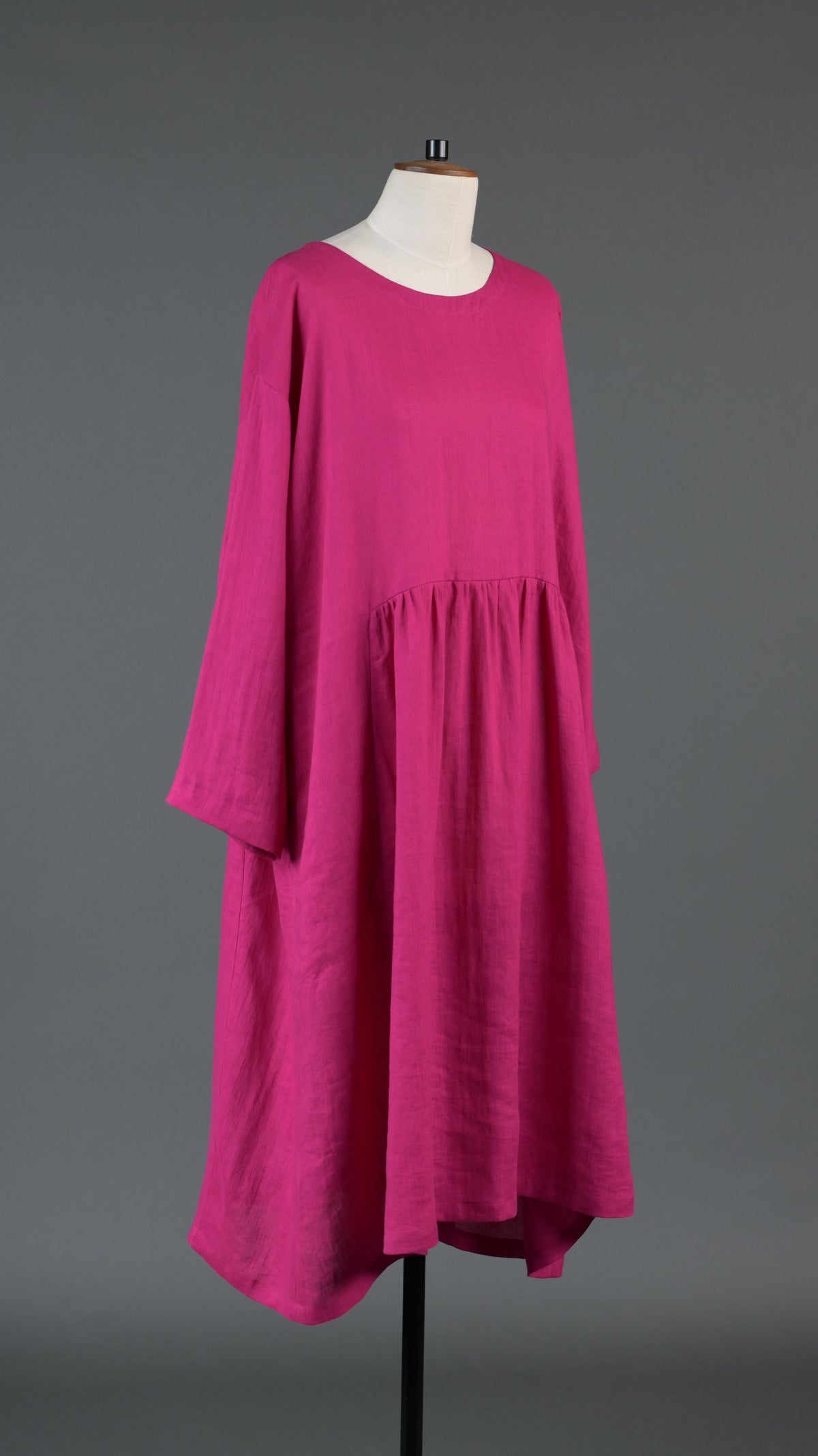 A-line round neck dress with pleated panels in lipstick