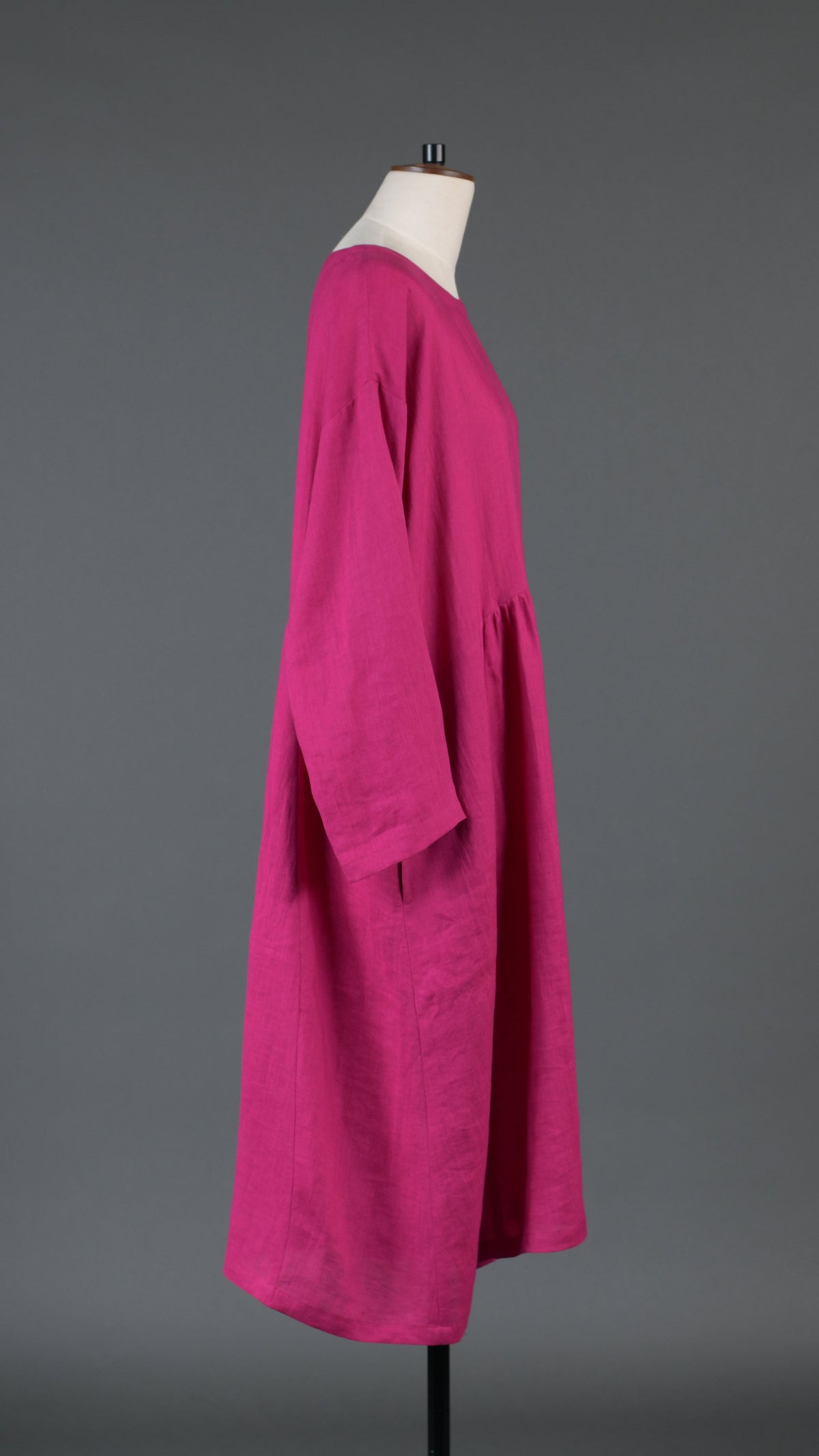 A-line round neck dress with pleated panels in lipstick
